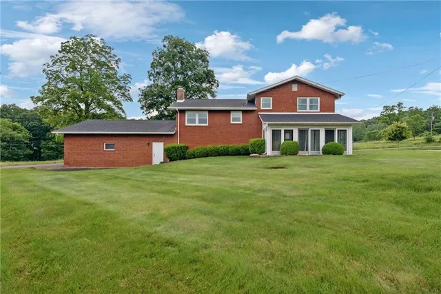 a view of a house with a backyard