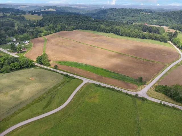 a view of a field with an ocean view
