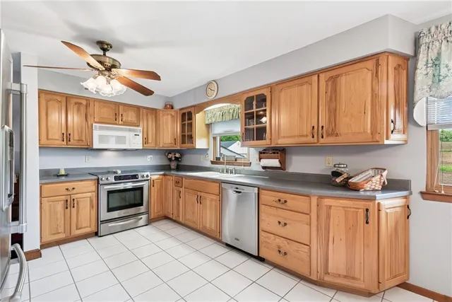 a kitchen with stainless steel appliances granite countertop a stove sink and cabinets