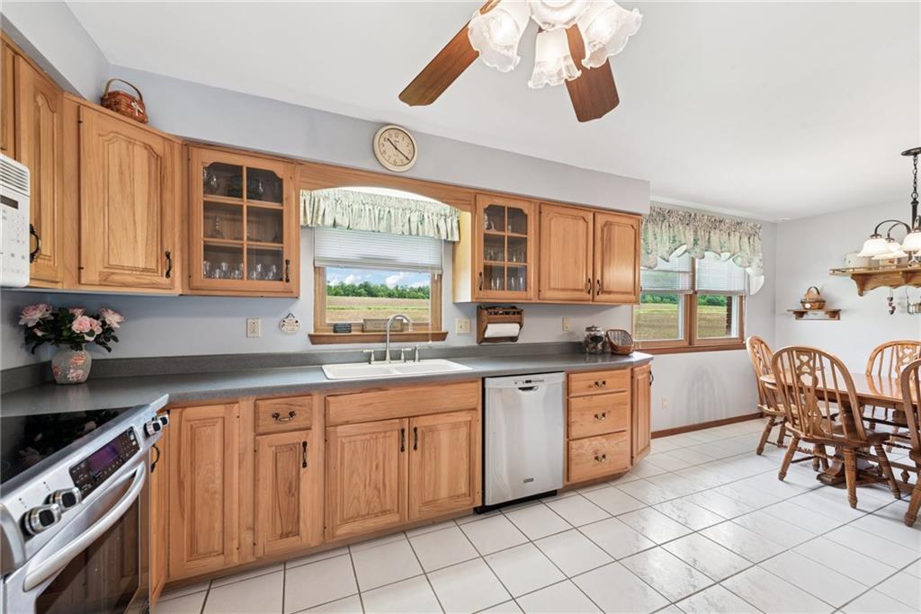 207 State Park Road New Alexandria, PA 15670 - Photo 10 of 38 a kitchen with stainless steel appliances granite countertop a stove a sink dishwasher and cabinets with wooden floor