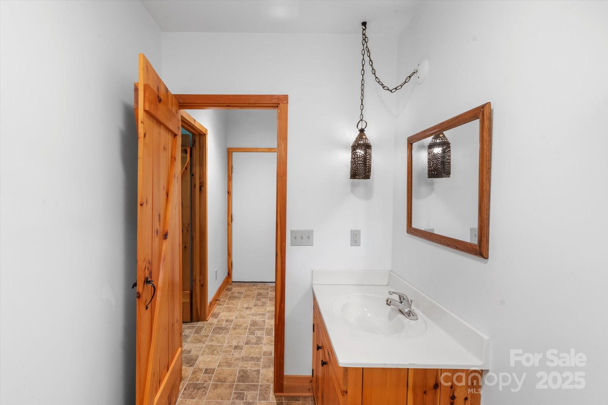 447 Cherokee Circle Tryon, NC 28782 - Photo 29 of 36 a bathroom with a sink and mirror