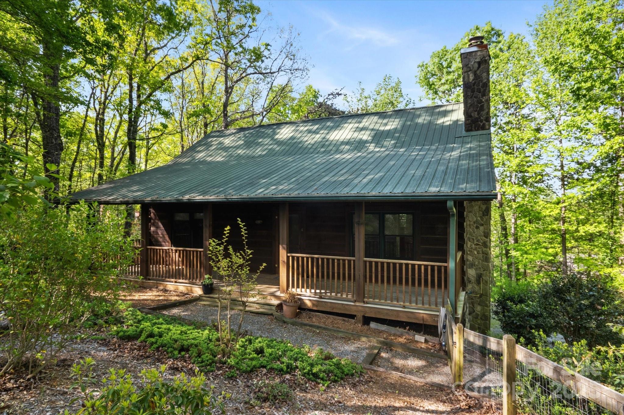 447 Cherokee Circle Tryon, NC 28782 - Photo 4 of 36 a view of a small house with a small yard and wooden fence