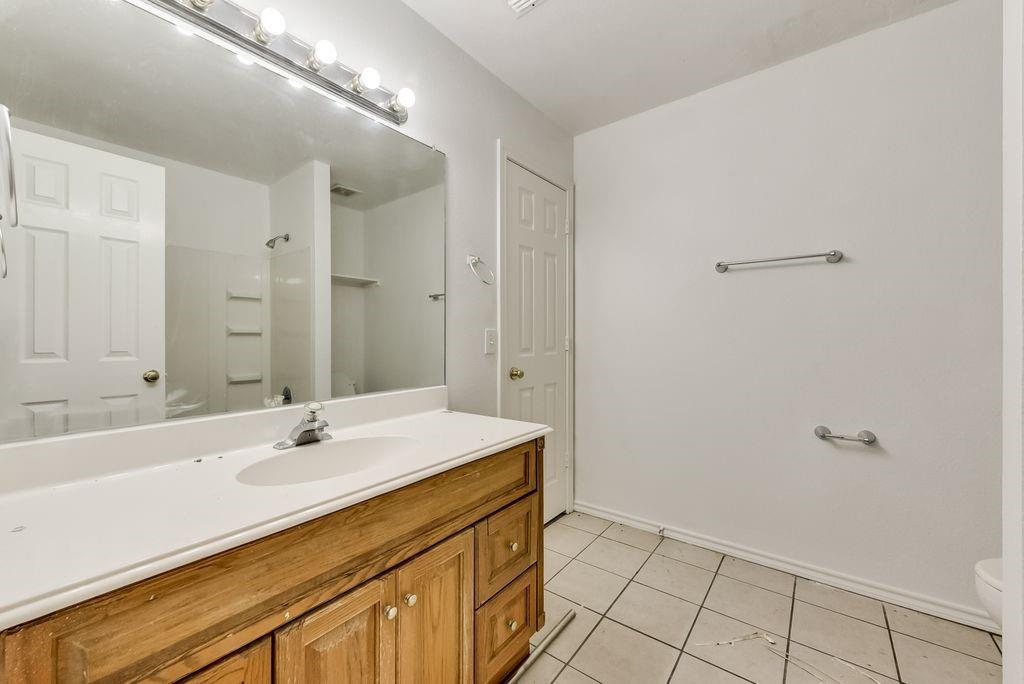 919 Farmington Road, Unit 919 Howe, TX 75459 - Photo 12 of 14 a bathroom with a sink a shower and a mirror