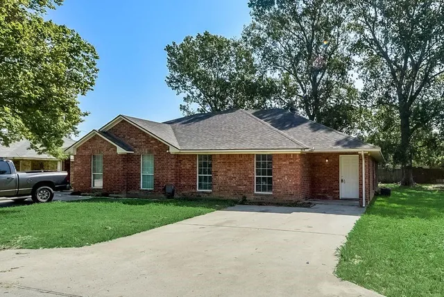 a front view of house with yard and green space