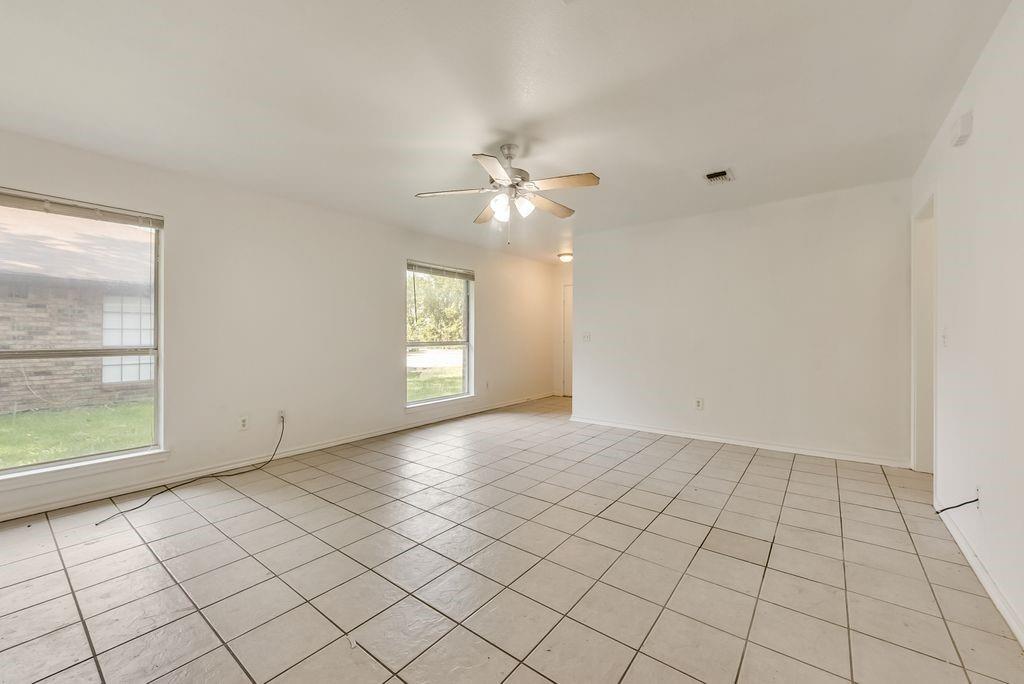919 Farmington Road, Unit 919 Howe, TX 75459 - Photo 4 of 14 an empty room with windows and fan