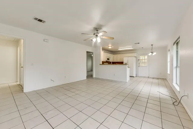 a view of a kitchen with a sink and a refrigerator