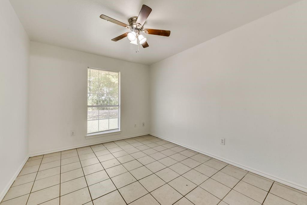 919 Farmington Road, Unit 919 Howe, TX 75459 - Photo 7 of 14 an empty room with windows and fan