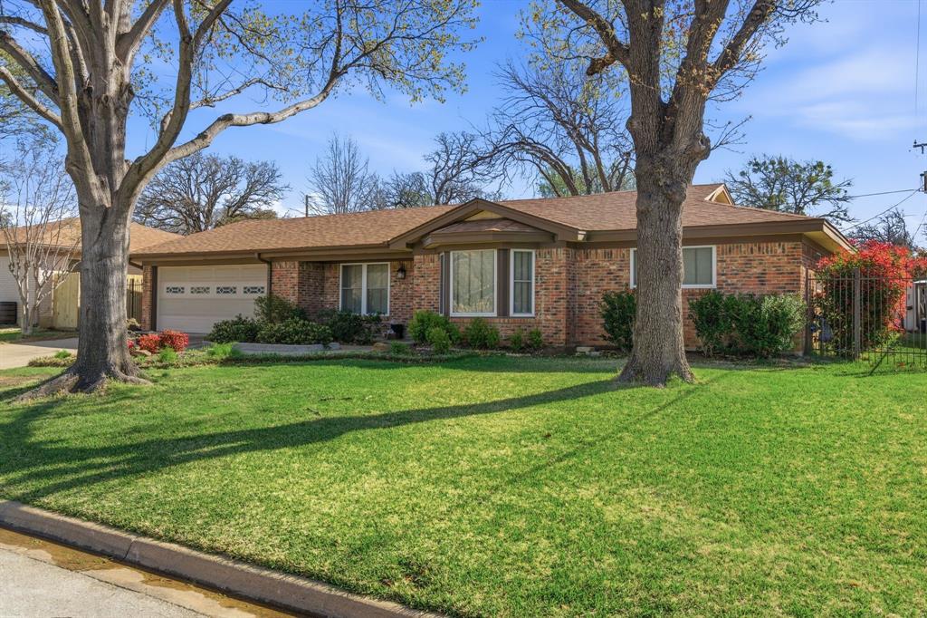 1760 Acorn Lane Hurst, TX 76054 - Photo 1 of 36 a front view of a house with garden
