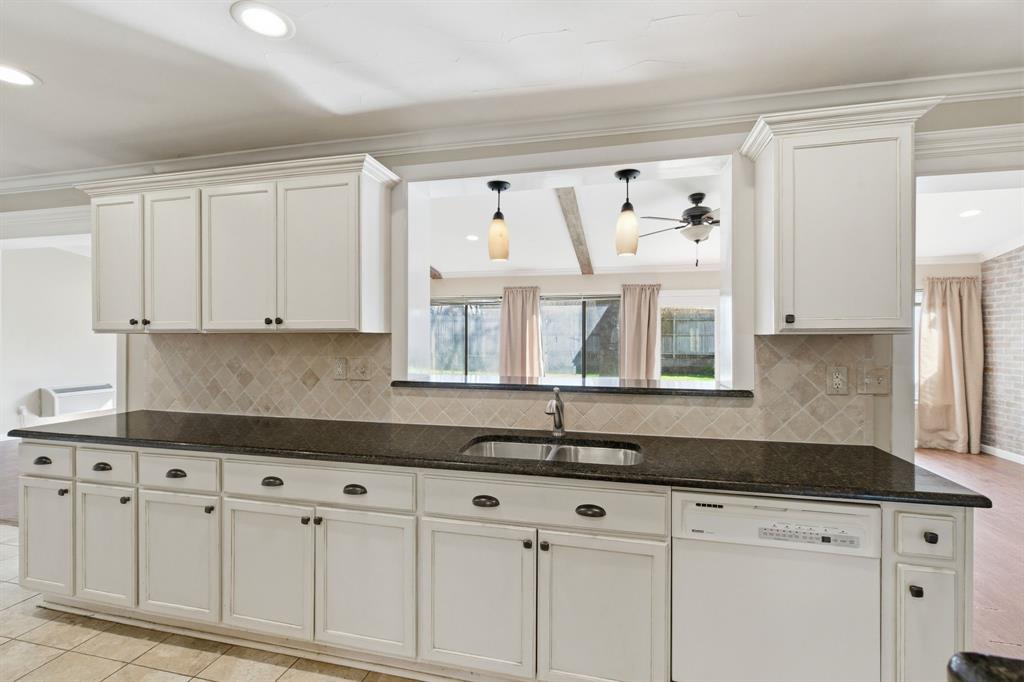 1760 Acorn Lane Hurst, TX 76054 - Photo 11 of 36 a kitchen with granite countertop white cabinets white appliances and a sink