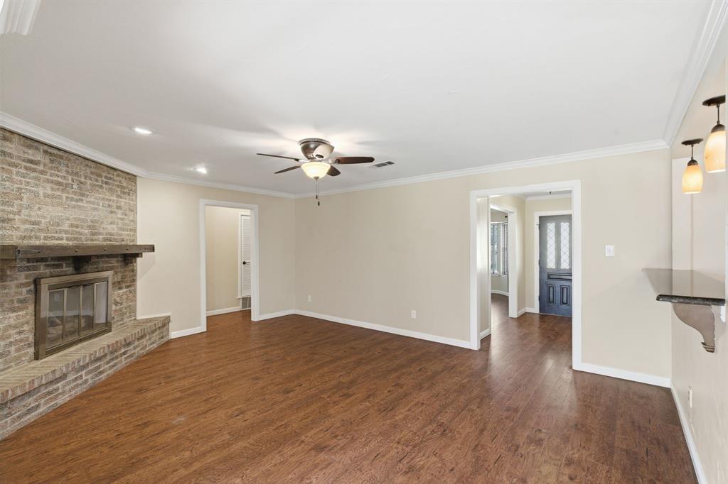 1760 Acorn Lane Hurst, TX 76054 - Photo 13 of 36 a view of an empty room with wooden floor and a fireplace