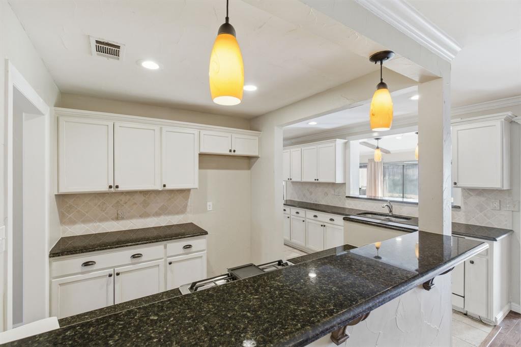 1760 Acorn Lane Hurst, TX 76054 - Photo 15 of 36 a kitchen with granite countertop a sink a stove and cabinets