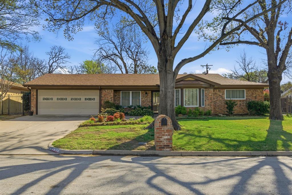 1760 Acorn Lane Hurst, TX 76054 - Photo 2 of 36 a front view of a house with a yard table and chairs