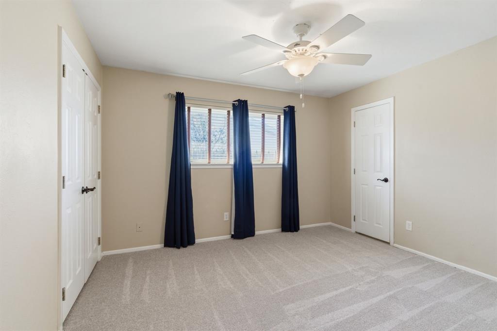 1760 Acorn Lane Hurst, TX 76054 - Photo 25 of 36 a view of an empty room with a ceiling fan