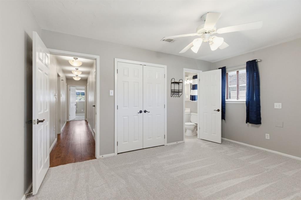 1760 Acorn Lane Hurst, TX 76054 - Photo 27 of 36 a view of a livingroom with a chandelier fan and windows