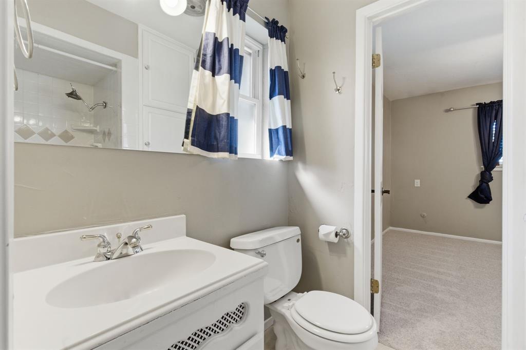 1760 Acorn Lane Hurst, TX 76054 - Photo 29 of 36 a bathroom with a sink a toilet and shower
