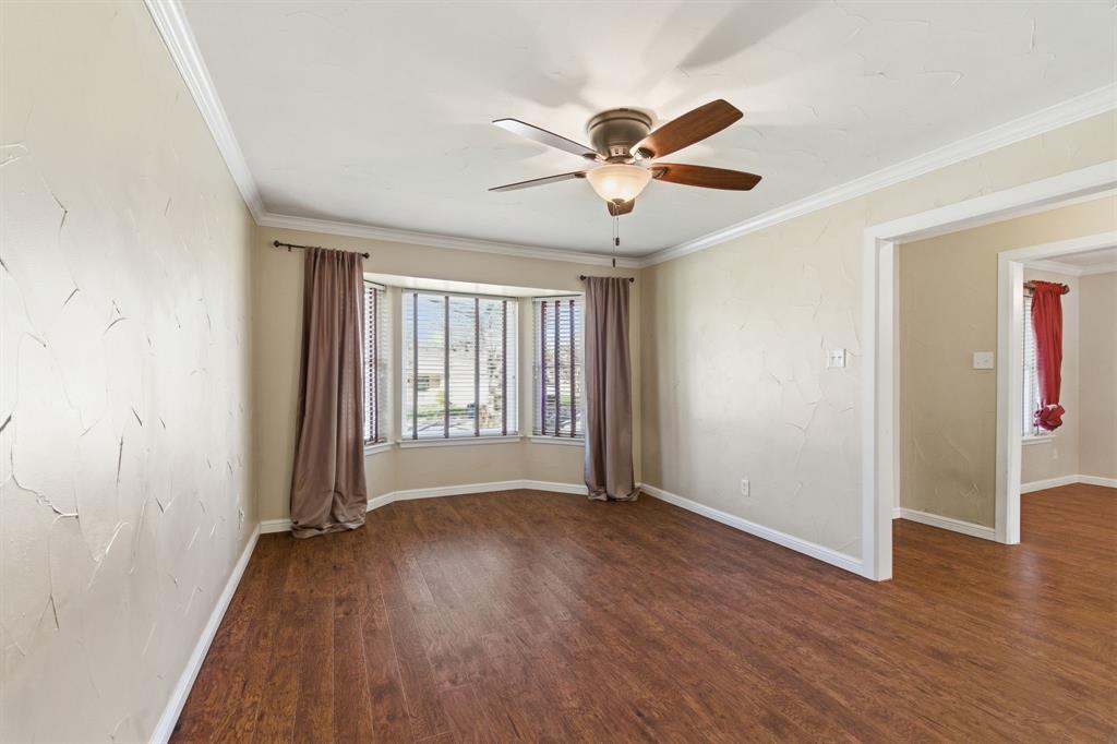 1760 Acorn Lane Hurst, TX 76054 - Photo 6 of 36 a view of an empty room with wooden floor and a window