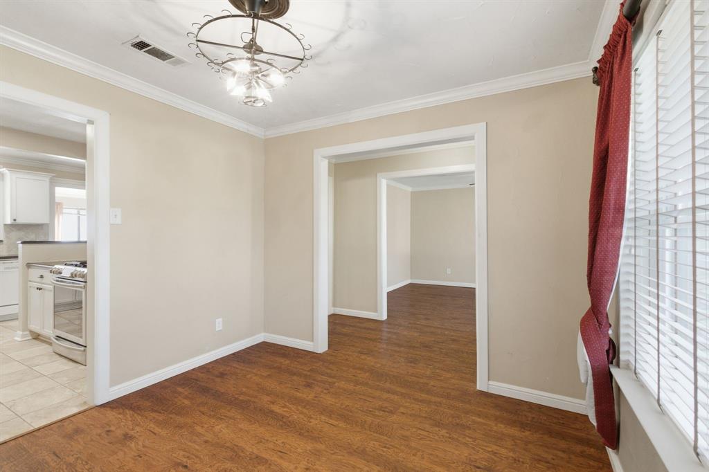 1760 Acorn Lane Hurst, TX 76054 - Photo 7 of 36 a view of an empty room with wooden floor and a window