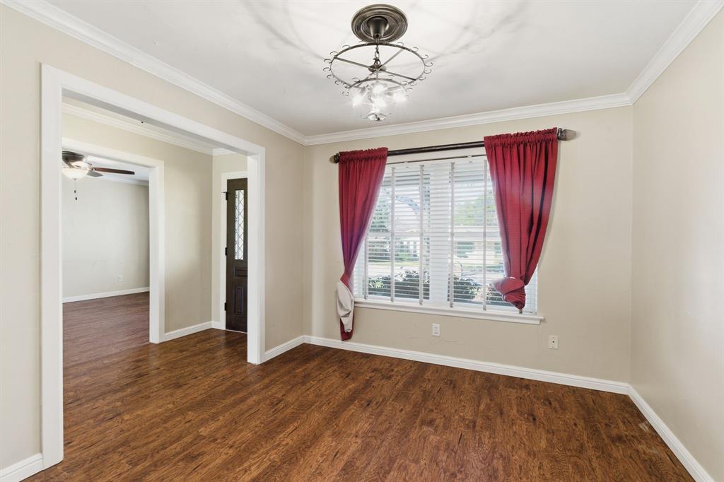 1760 Acorn Lane Hurst, TX 76054 - Photo 8 of 36 a view of an empty room with wooden floor and a window