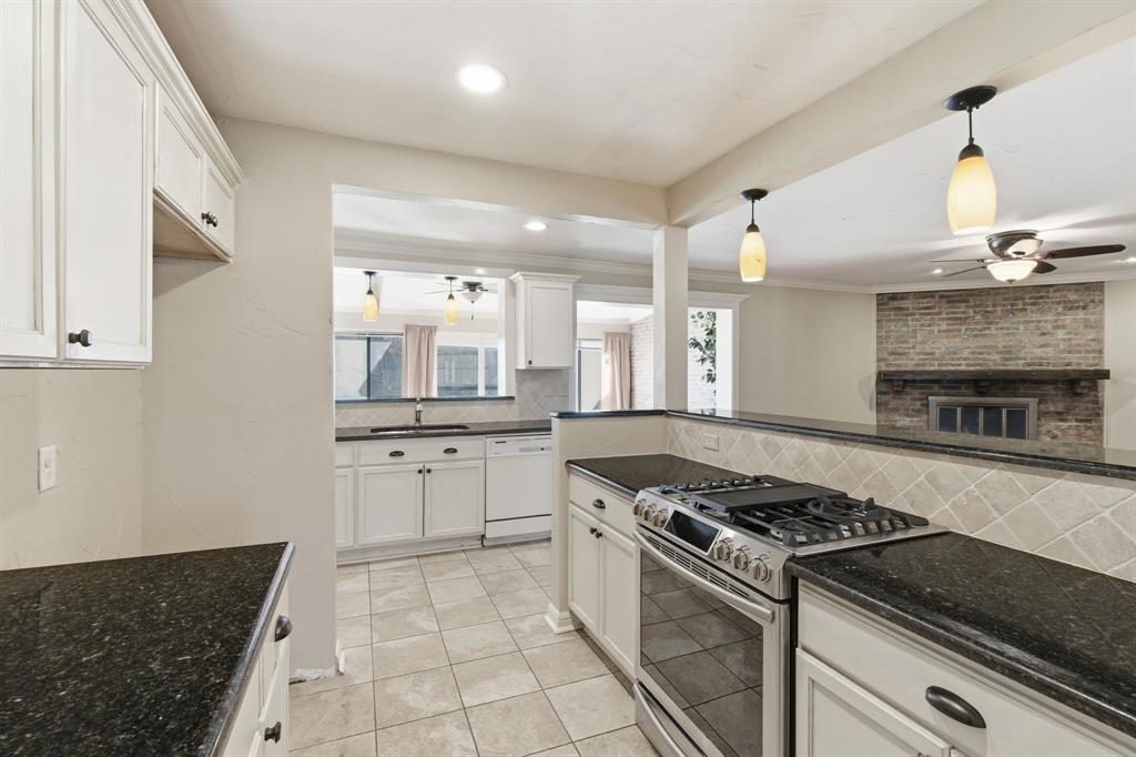 1760 Acorn Lane Hurst, TX 76054 - Photo 9 of 36 a kitchen with a stove and a sink