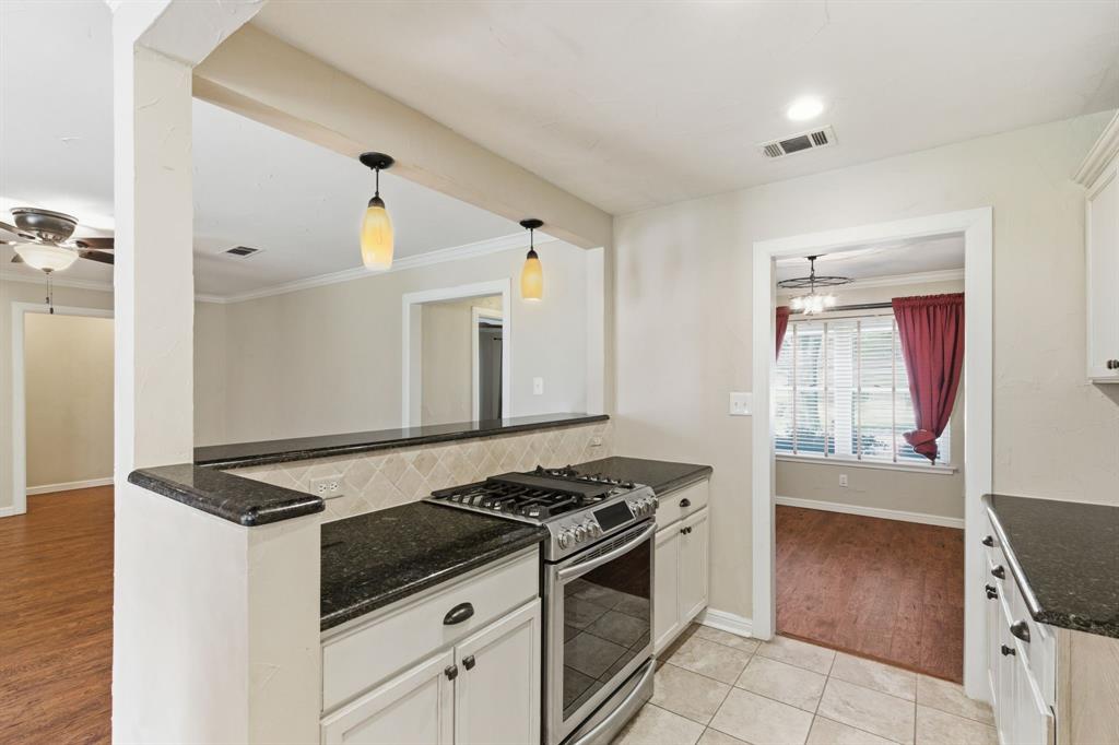 1760 Acorn Lane Hurst, TX 76054 - Photo 10 of 36 a kitchen with granite countertop a stove and a sink