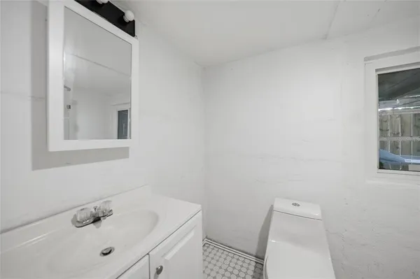 a bathroom with a sink toilet and vanity