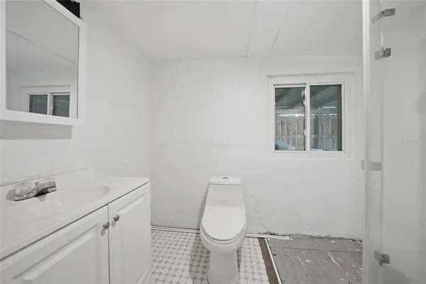 a bathroom with a sink toilet and vanity