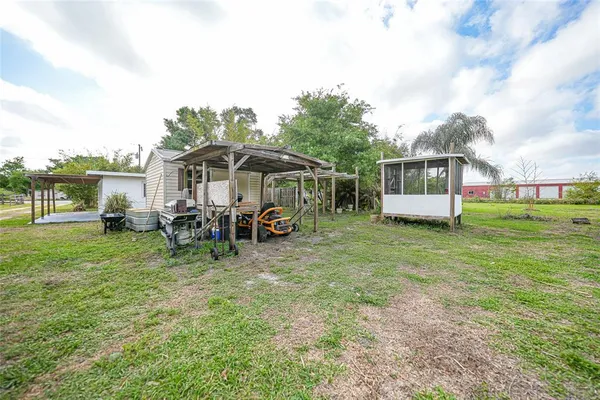 a view of a house with backyard porch and sitting area