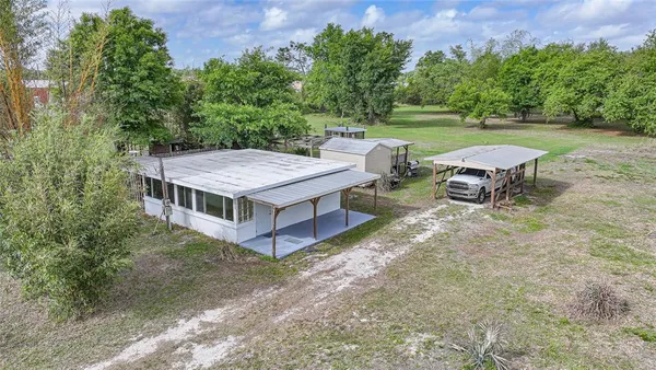 an aerial view of a house with a yard table and chairs