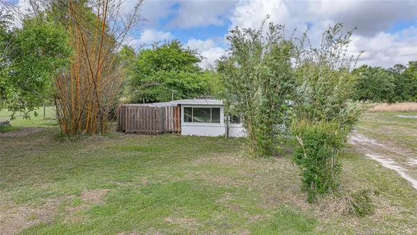 a backyard of a house with lots of green space