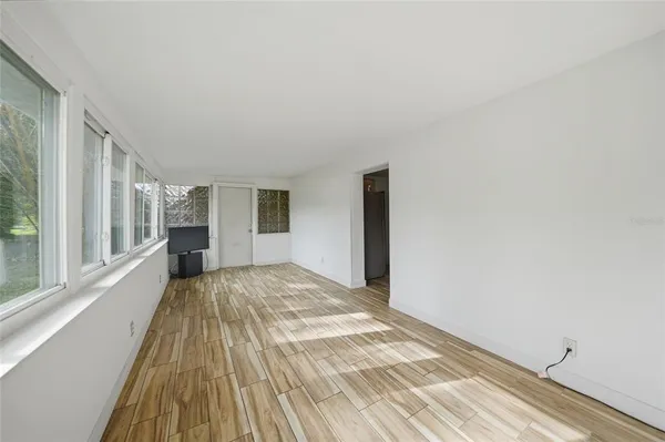 a view of a bedroom with a bed and wooden floor