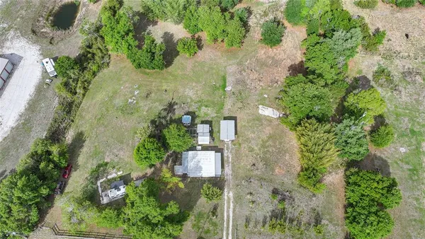 an aerial view of a house with a yard
