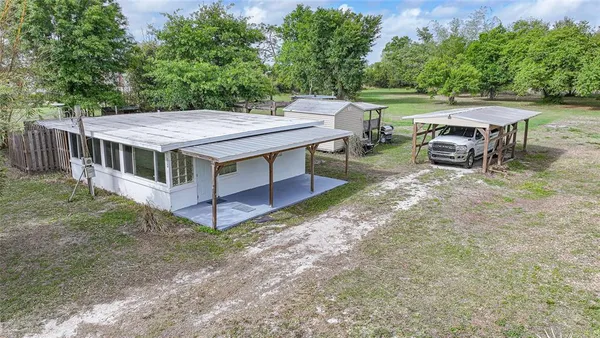 a view of a house with backyard and a hammock