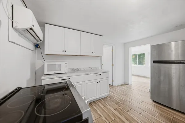 a kitchen with a refrigerator sink and cabinets