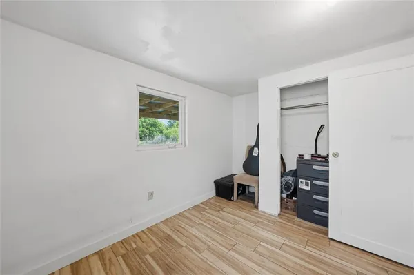 a view of a room with wooden floor lounge chair and a window