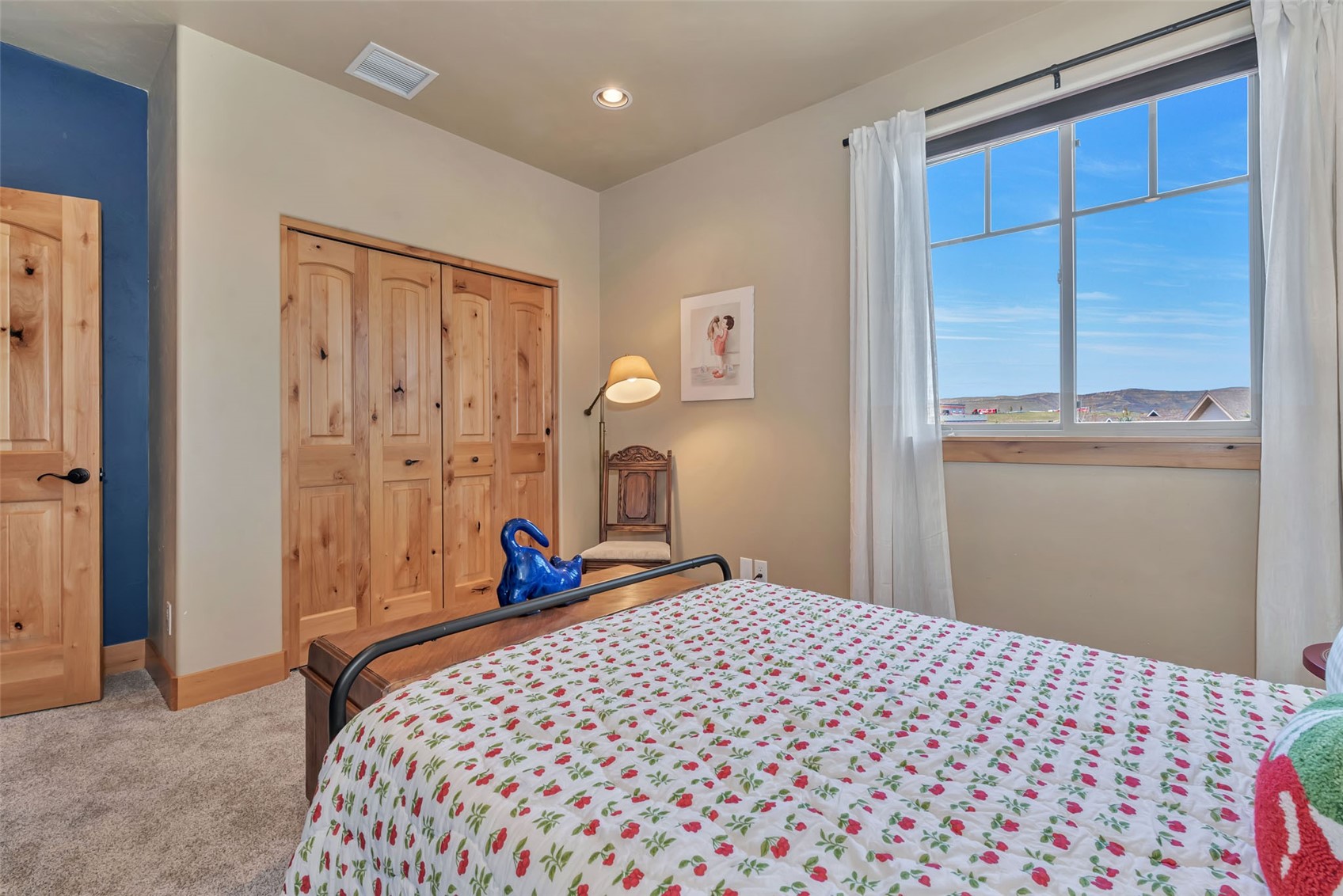 938 South Dry Creek Road Hayden, CO 81639 - Photo 30 of 34 a bedroom with a large bed and a chandelier