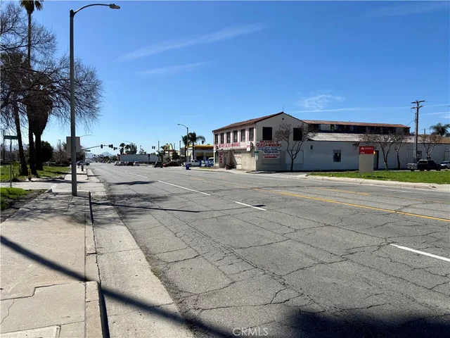 a front view of a building with palm trees