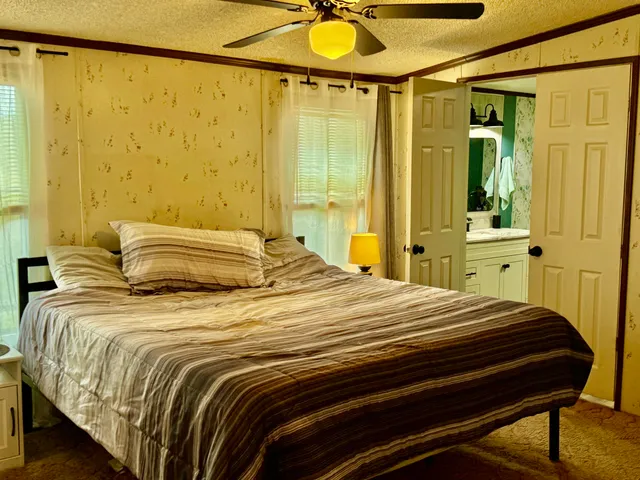 a bedroom with a bed and a chandelier