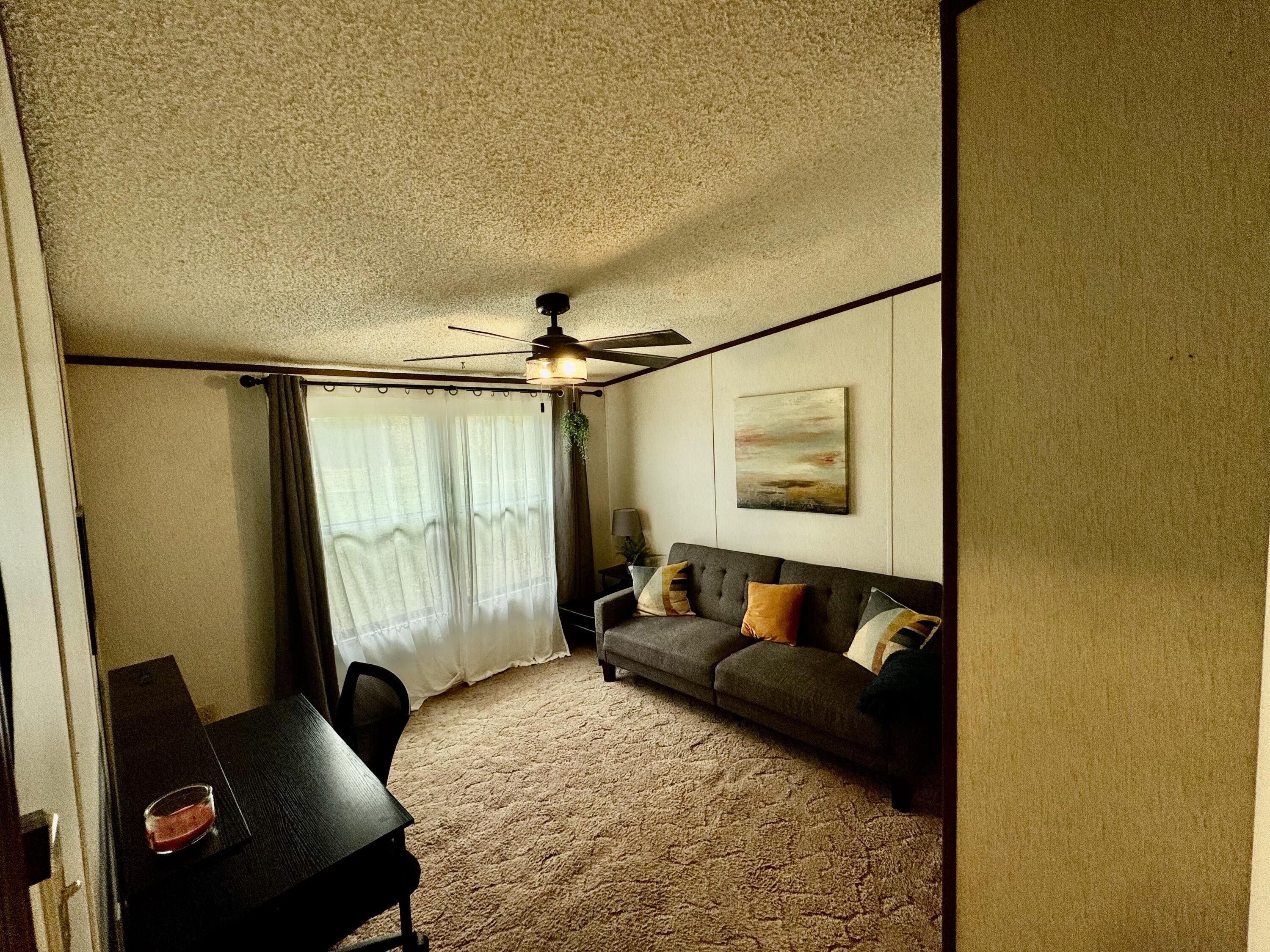 6249 Joppa Mill Road Moneta, VA 24121 - Photo 16 of 55 a living room with furniture and a window