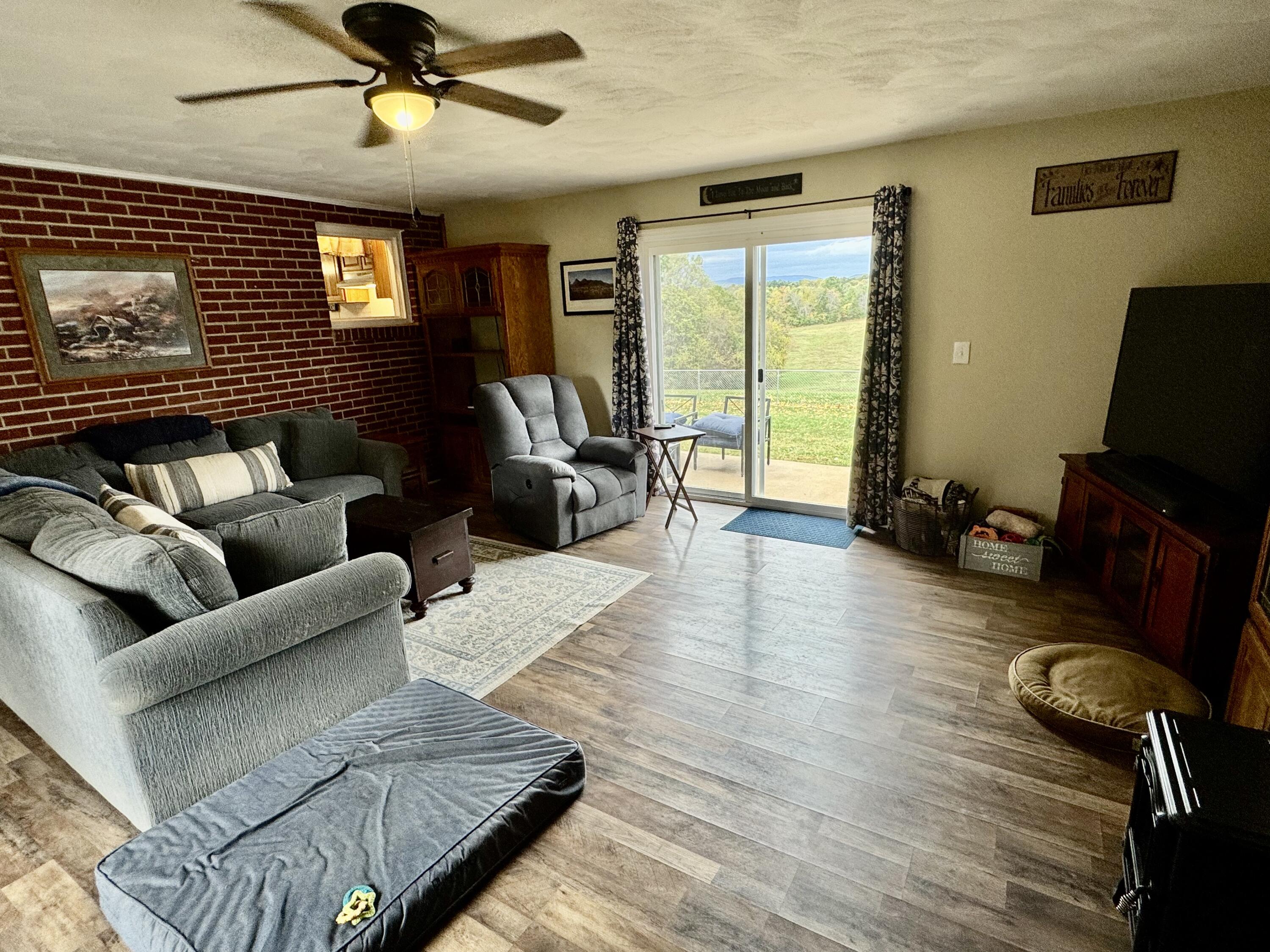6249 Joppa Mill Road Moneta, VA 24121 - Photo 35 of 55 a living room with furniture ceiling fan and a wooden floor