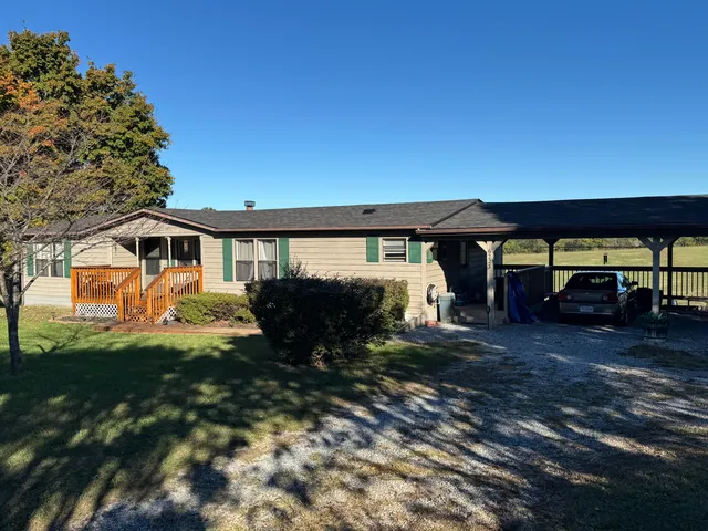 a view of a house with backyard porch and sitting area