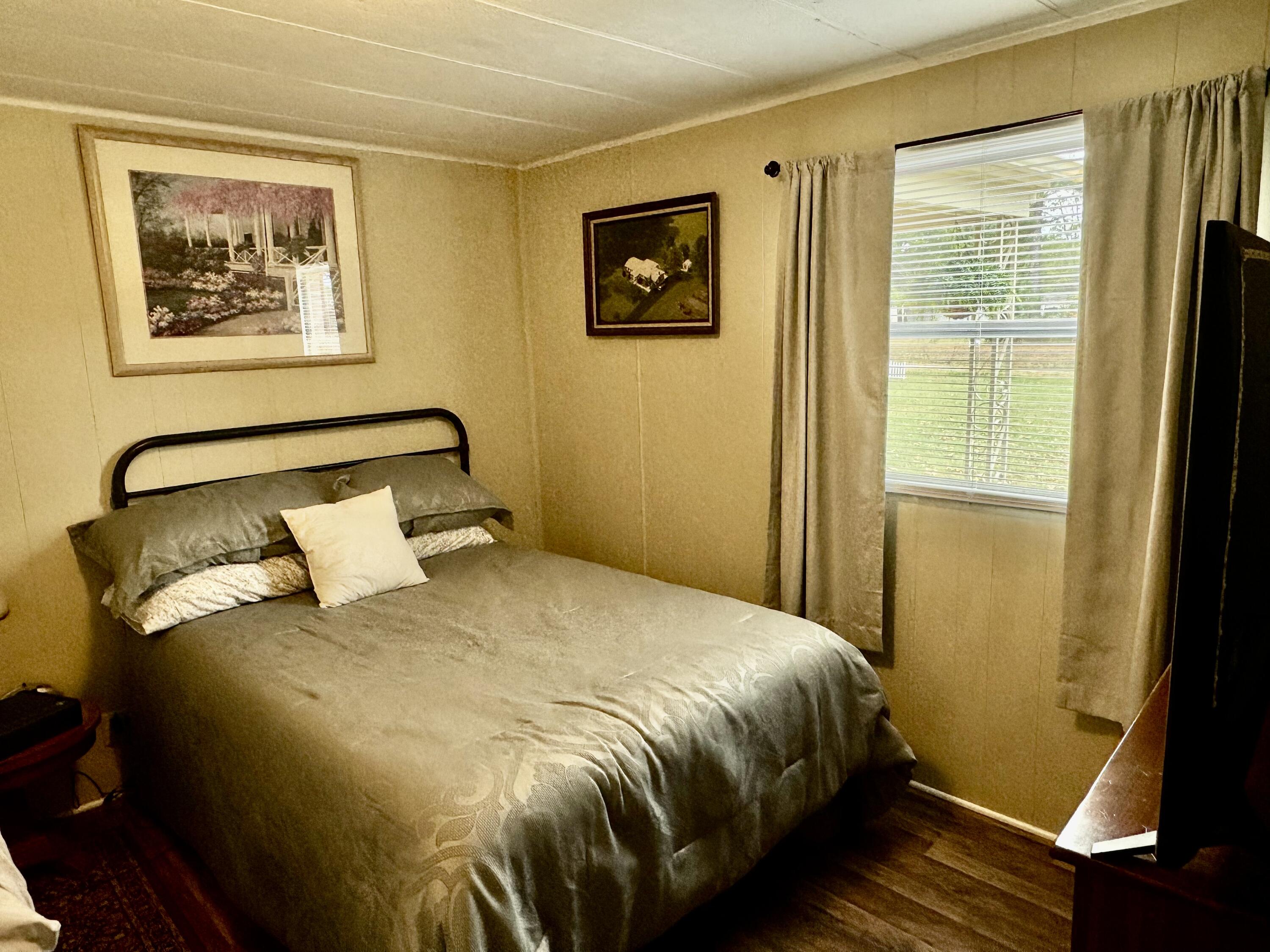 6249 Joppa Mill Road Moneta, VA 24121 - Photo 41 of 55 a bedroom with a bed and wooden floor