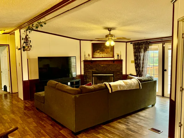 a living room with furniture a flat screen tv and a fireplace