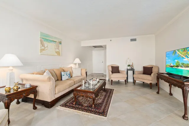 a kitchen with stainless steel appliances granite countertop table chairs and a refrigerator