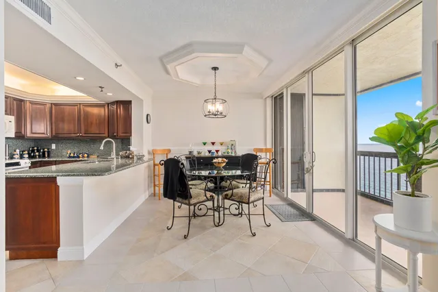 a kitchen with stainless steel appliances granite countertop a refrigerator a sink a stove a microwave and island