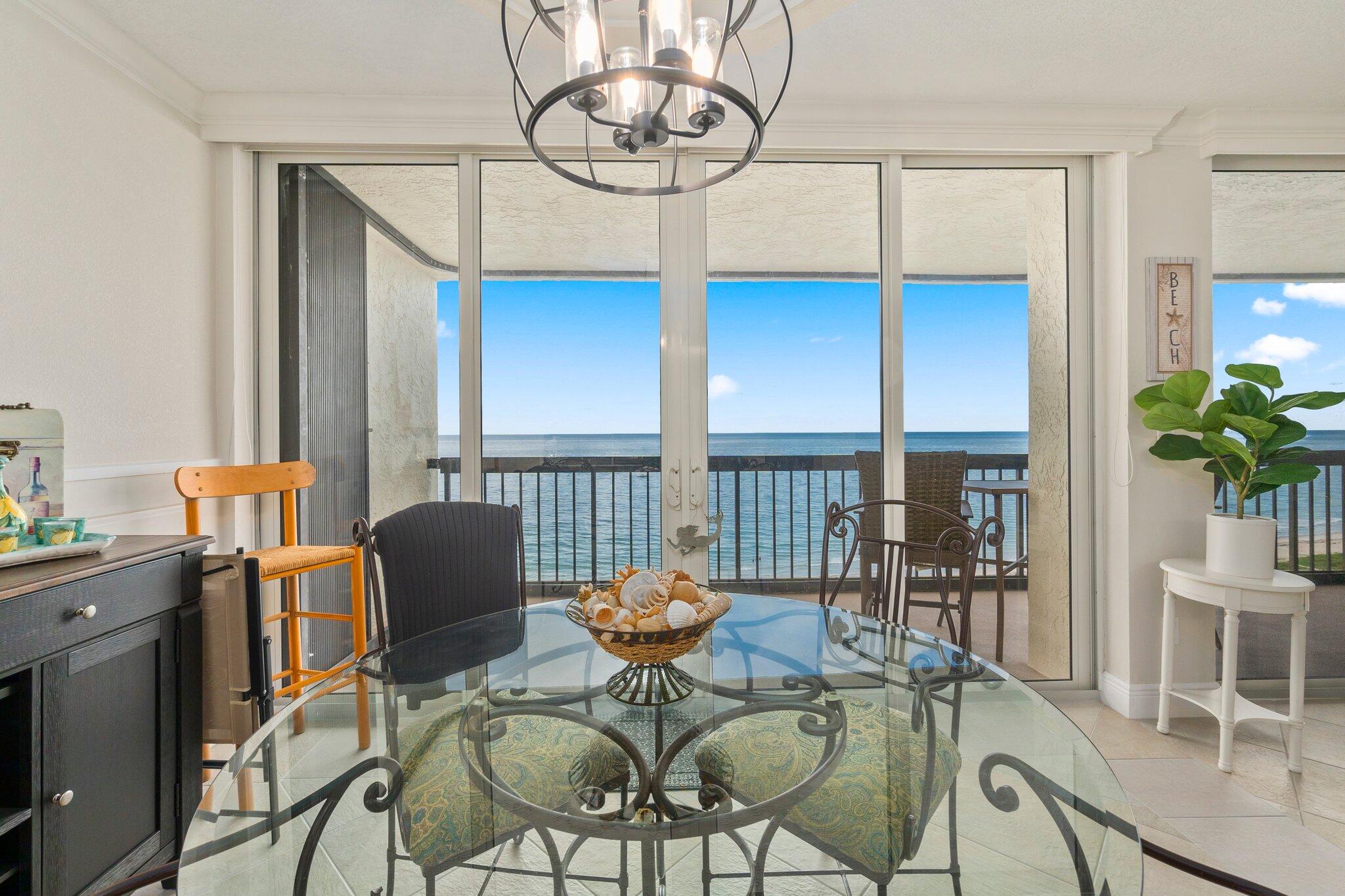 3100 North Hwy A1A, Unit PHA4 Fort Pierce, FL 34949 - Photo 15 of 54 a living room with furniture a dining table and a floor to ceiling window