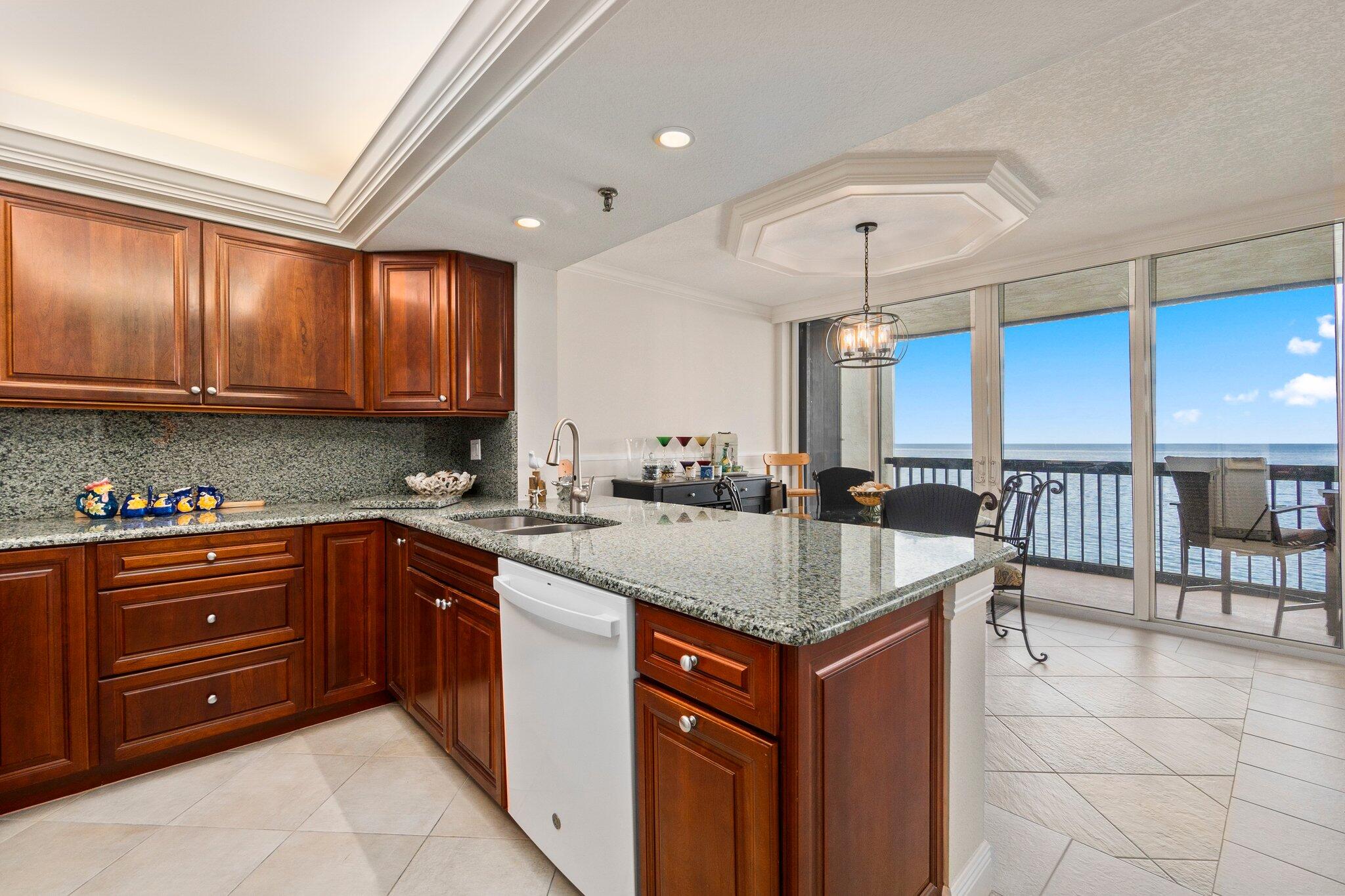 3100 North Hwy A1A, Unit PHA4 Fort Pierce, FL 34949 - Photo 17 of 54 a kitchen with a sink cabinets and window