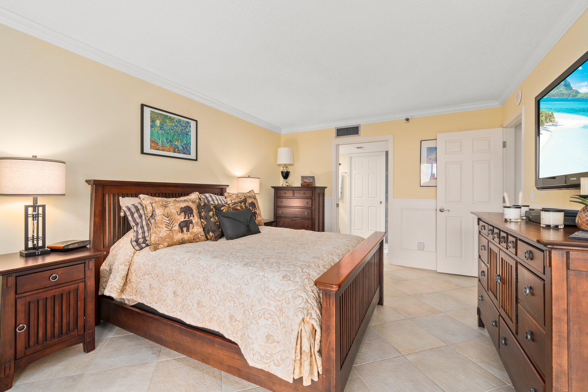 3100 North Hwy A1A, Unit PHA4 Fort Pierce, FL 34949 - Photo 26 of 54 a spacious bedroom with a bed and a lamp on table