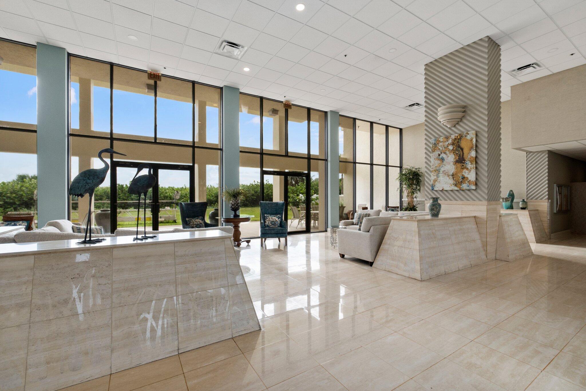 3100 North Hwy A1A, Unit PHA4 Fort Pierce, FL 34949 - Photo 5 of 54 a view of lobby with furniture and floor to ceiling window