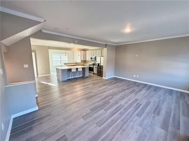 a view of a livingroom with furniture wooden floor and window
