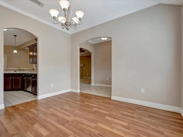 a view of a kitchen with a sink and a chandelier